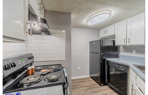 a kitchen with stainless steel appliances and white cabinets